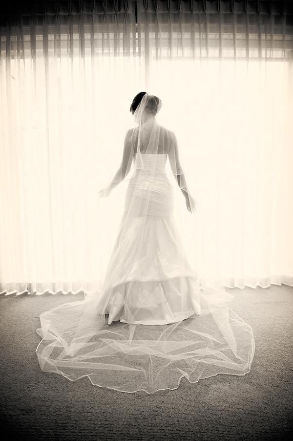 portrait of bride standing in front of window - photo by Houston based wedding photographer Adam Nyholt